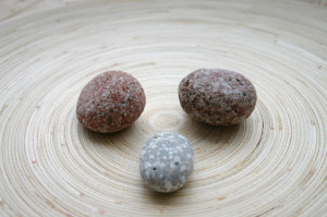 Three Rocks on a wood surface