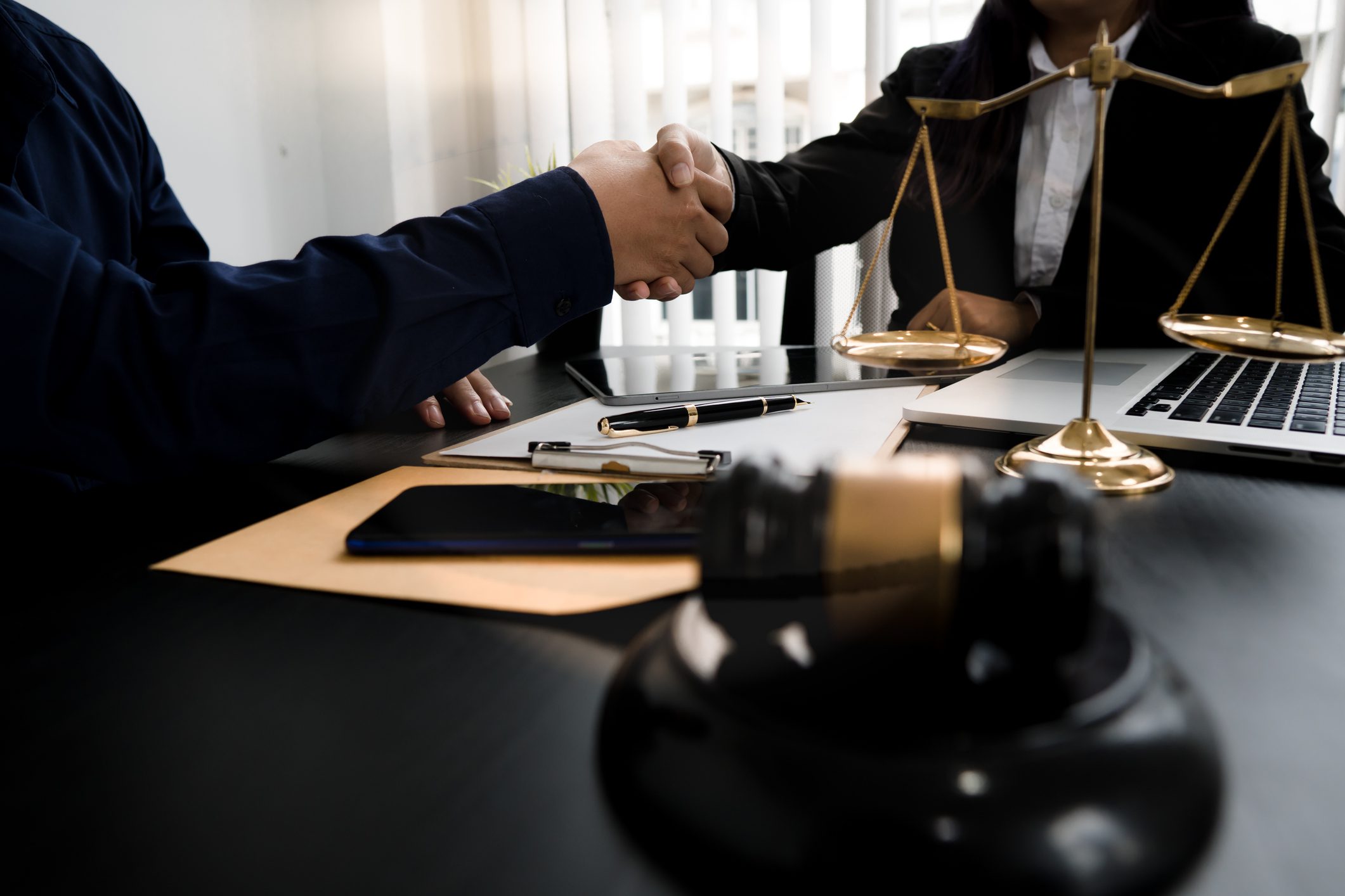 Business agreement with scales and gavel
