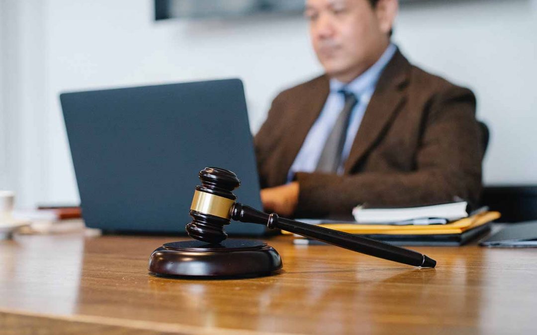Lawyer using laptop near a gavel